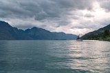 1881 - TSS Earnslaw tourist cruise heads out of Queenstown under a sunset on Lake Wakatipu